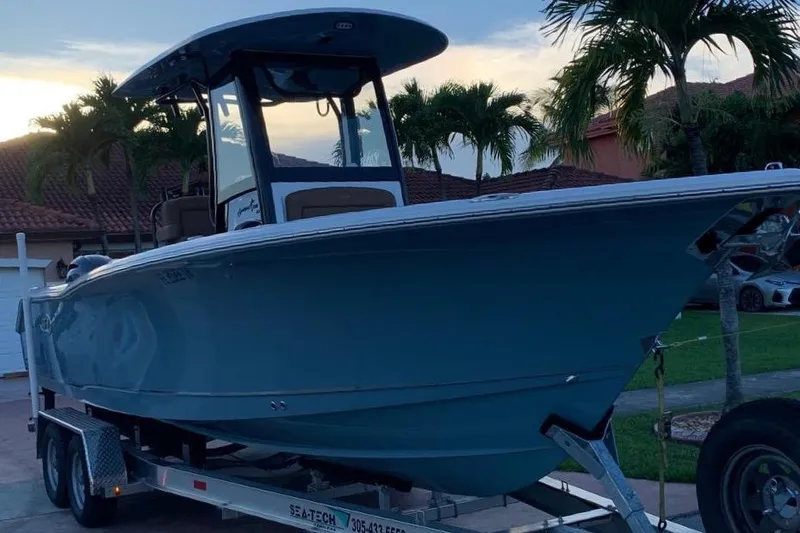 Slide: The Image of 2022 Sea Hunt Gamefish 25 boat on trailer, parked in residential area. - 1