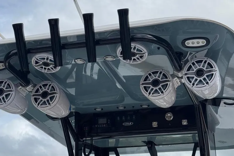 Slide: The Image of 2022 Sea Hunt Gamefish 25 boat speakers and rod holders on T-top. - 14