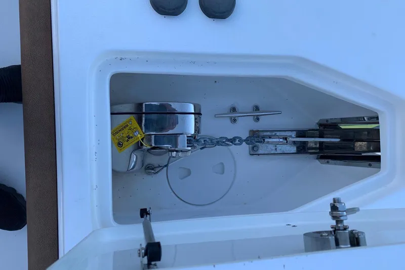 Slide: The Image of 2022 Sea Hunt Gamefish 25 anchor compartment with chain and cleat. - 18