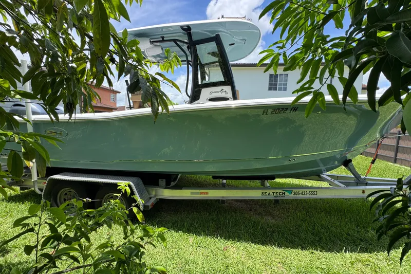 Slide: The Image of 2022 Sea Hunt Gamefish 25 boat on trailer, parked in residential area. - 23