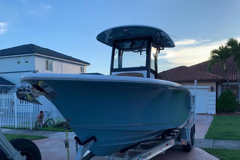 Slide: The Image of 2022 Sea Hunt Gamefish 25 boat on trailer, parked in residential driveway. - 3