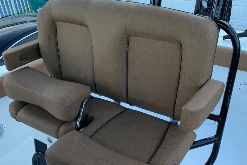 Slide: The Image of Brown cushioned seat on 2022 Sea Hunt Gamefish 25 boat, featuring armrests and sturdy design. - 5