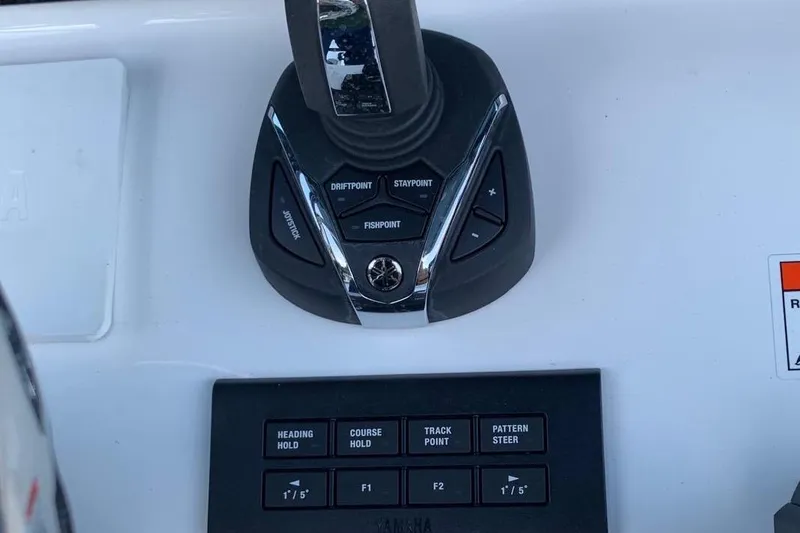 Slide: The Image of Control panel of 2022 Sea Hunt Gamefish 25 boat with joystick and navigation buttons. - 9