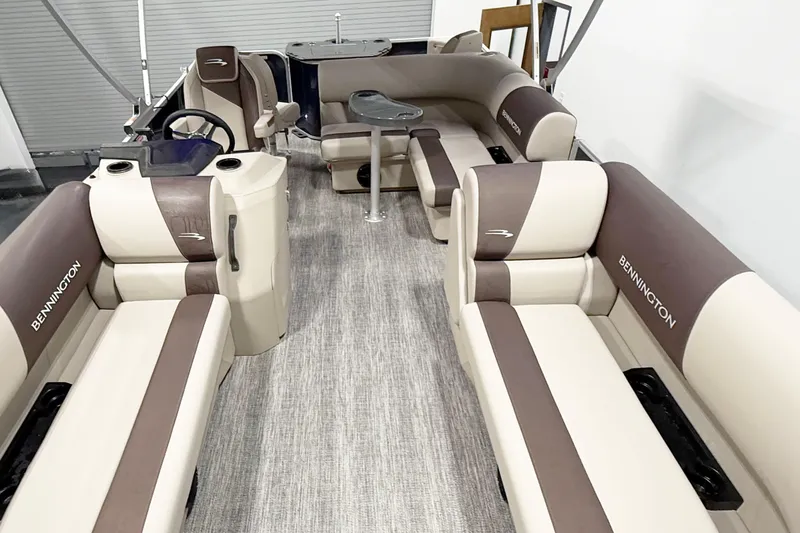 Slide: The Image of 2025 Bennington 20S pontoon boat interior with beige and brown seating, modern design. - 11