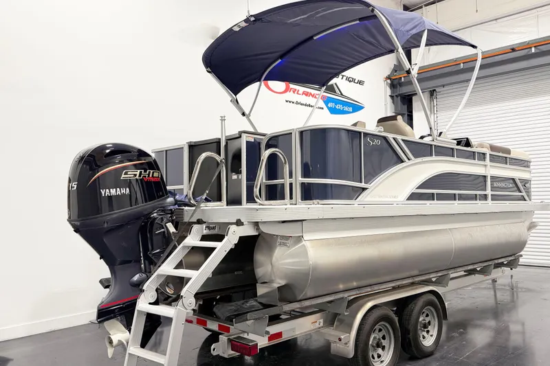 Slide: The Image of 2025 Bennington 20S pontoon boat with Yamaha engine on trailer in showroom. - 3