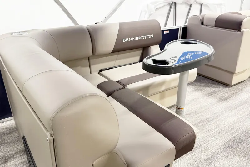 Slide: The Image of Luxurious seating in 2025 Bennington 20S pontoon boat with stylish table and cup holders. - 7