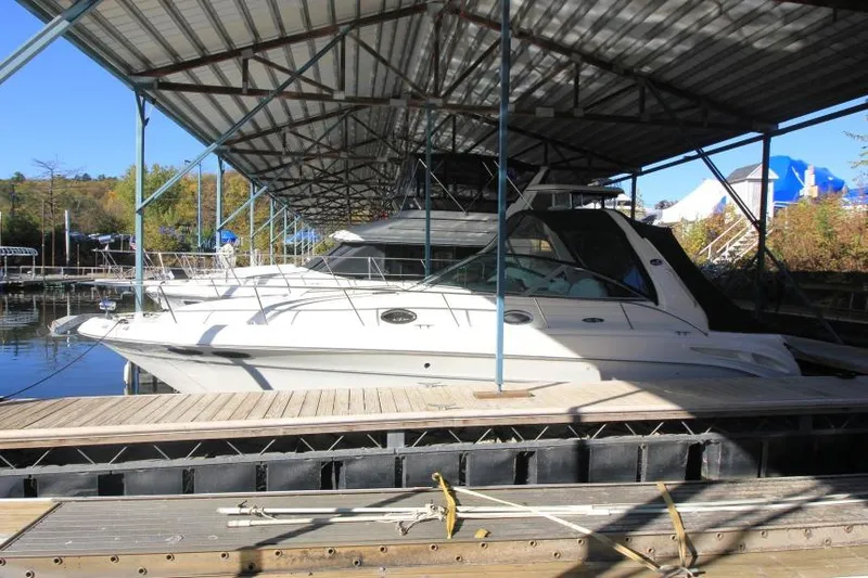 The Image of 2000 Sea Ray 340 Sundancer docked under a covered marina. - 0