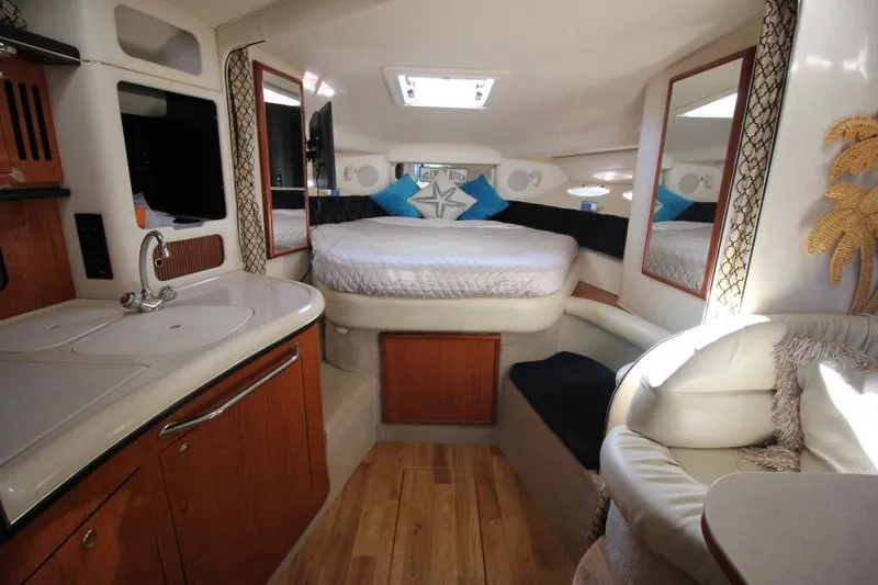 Slide: The Image of Interior of 2000 Sea Ray 340 Sundancer yacht with cozy bed and kitchenette. - 12