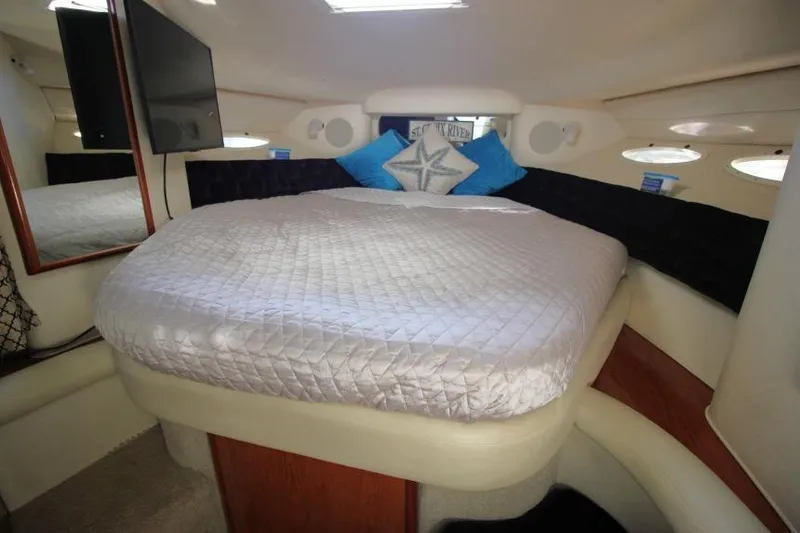 Slide: The Image of Interior cabin of 2000 Sea Ray 340 Sundancer with bed and pillows. - 13