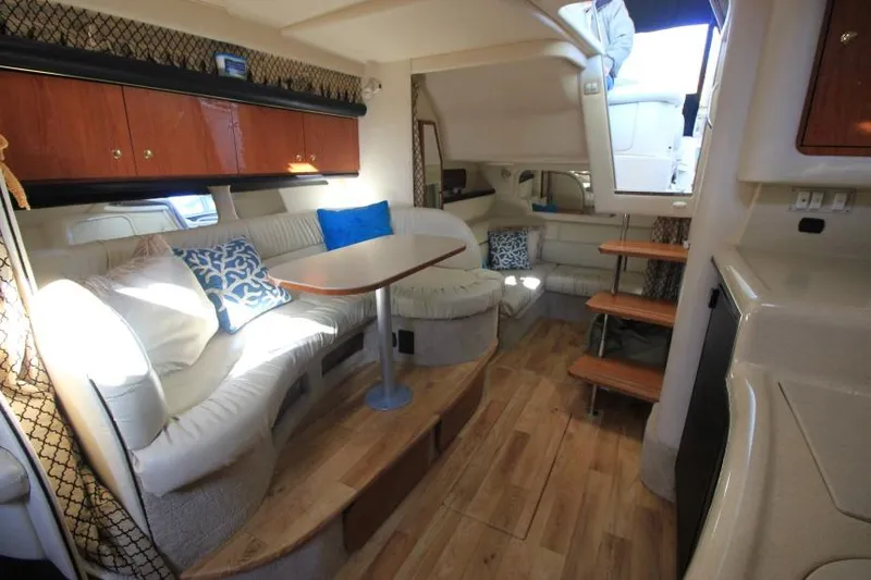 Slide: The Image of Interior of 2000 Sea Ray 340 Sundancer yacht with cozy seating and wooden flooring. - 15