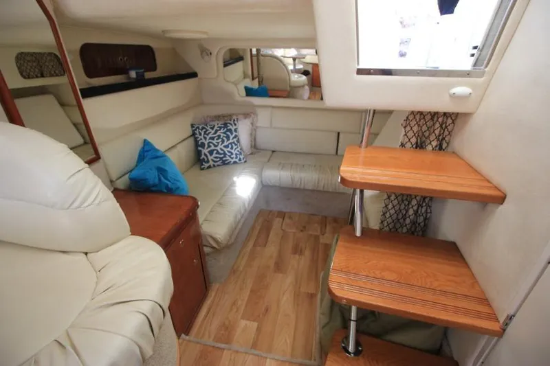 Slide: The Image of Interior of 2000 Sea Ray 340 Sundancer yacht with cozy seating and wooden steps. - 16