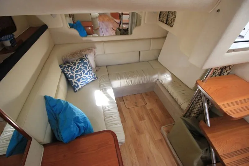 Slide: The Image of Interior of 2000 Sea Ray 340 Sundancer with beige seating and decorative pillows. - 17