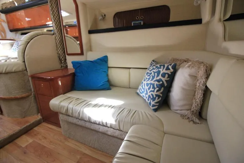 Slide: The Image of Interior of 2000 Sea Ray 340 Sundancer with beige seating and decorative pillows. - 18