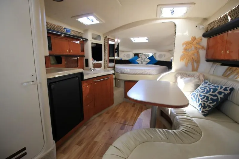 Slide: The Image of Interior of 2000 Sea Ray 340 Sundancer yacht with kitchen, seating, and bed. - 19