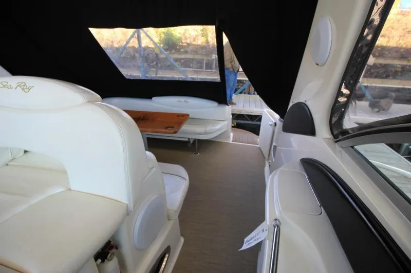 Slide: The Image of Interior of 2000 Sea Ray 340 Sundancer yacht with white seating and wooden table. - 4