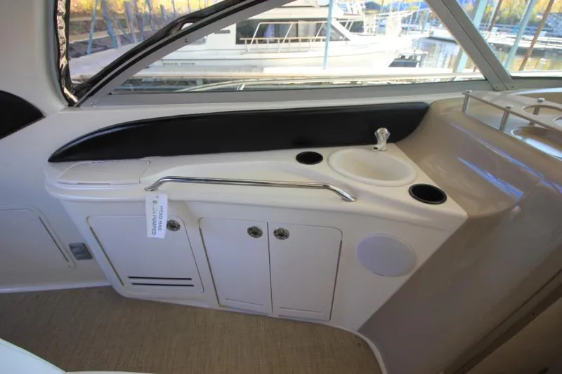 Slide: The Image of 2000 Sea Ray 340 Sundancer interior with sink and storage cabinets. - 5