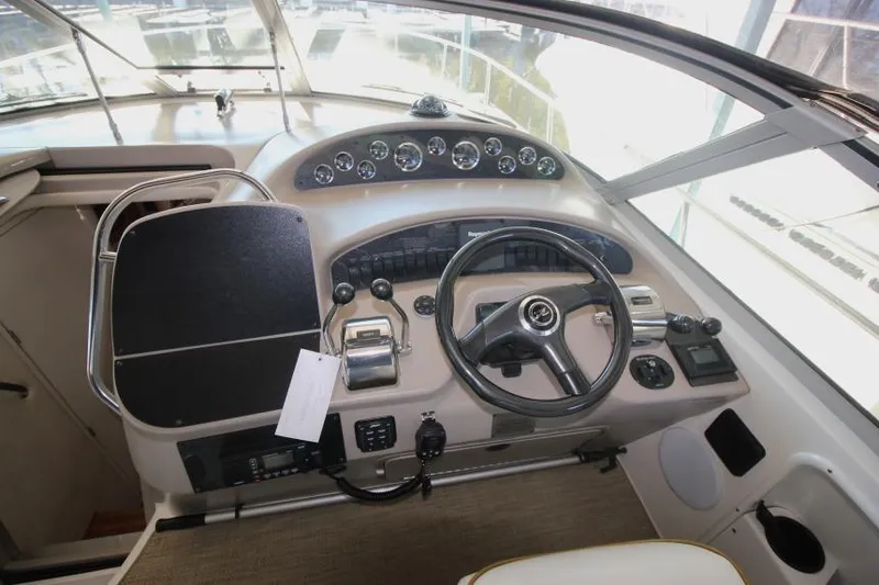 Slide: The Image of Cockpit of 2000 Sea Ray 340 Sundancer with steering wheel and control panel. - 6