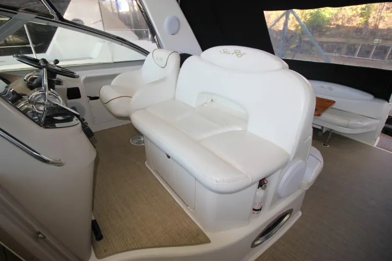 Slide: The Image of Interior of 2000 Sea Ray 340 Sundancer with white seating and steering area. - 7