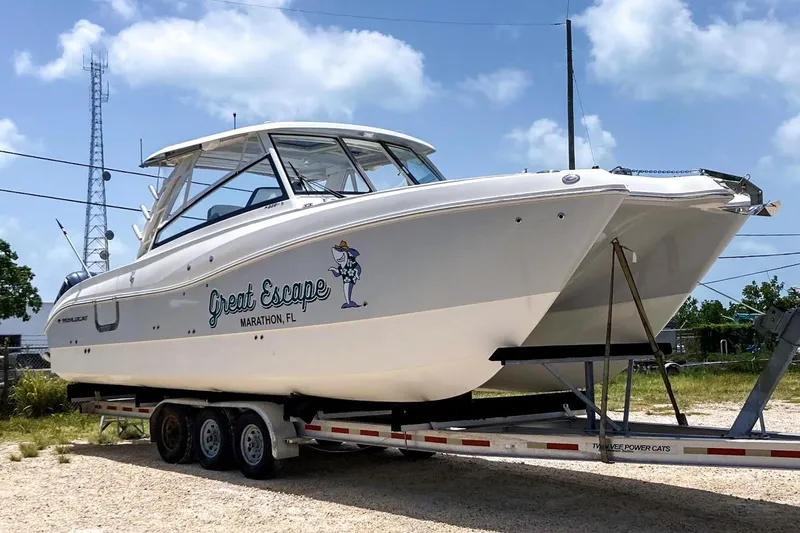 Slide: The Image of 2021 World Cat 325 DC boat on trailer, labeled "Great Escape," Marathon, FL. - 6
