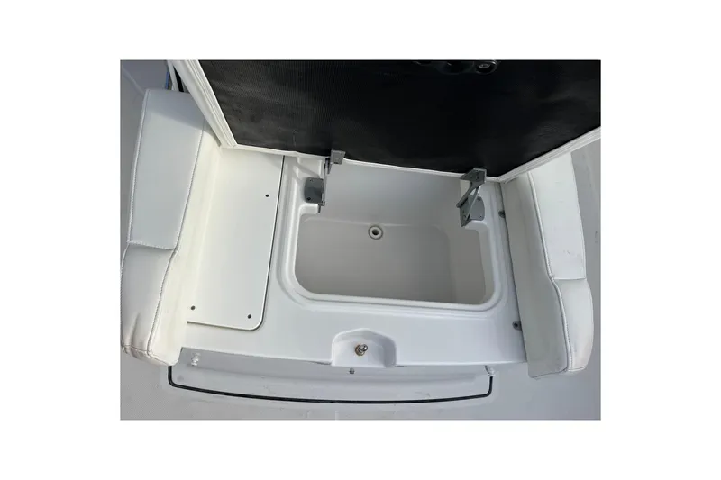 Slide: The Image of 2019 Blackfin 272 CC boat storage compartment with open lid and white seating. - 10