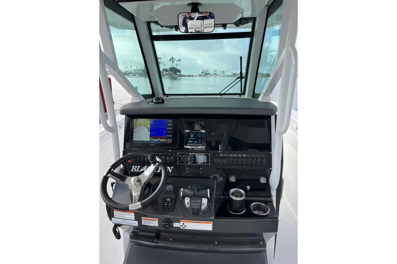 Slide: The Image of 2019 Blackfin 272 CC boat dashboard with steering wheel and navigation displays. - 15