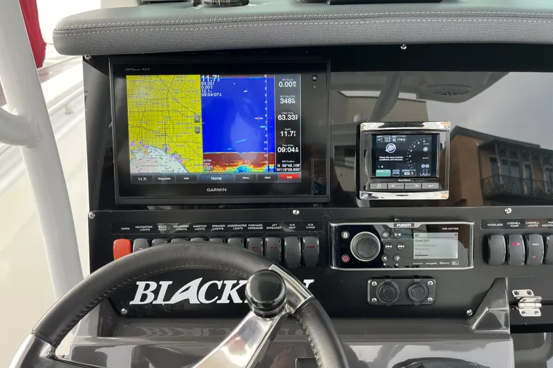 Slide: The Image of 2019 Blackfin 272 CC dashboard with Garmin navigation and control systems. - 16