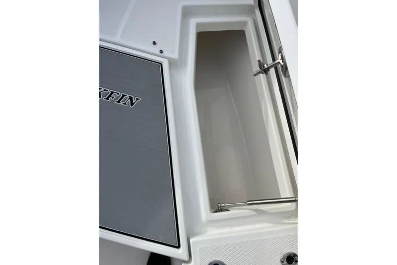 Slide: The Image of 2019 Blackfin 272 CC boat storage compartment with open lid and hydraulic support. - 35