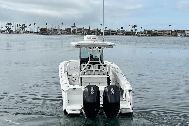 Slide: The Image of 2019 Blackfin 272 CC boat with dual engines on calm water, coastal background. - 4