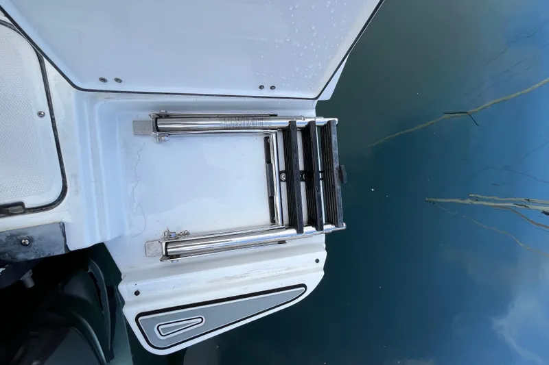 Slide: The Image of 2019 Blackfin 272 CC swim platform with retractable ladder by the water. - 41