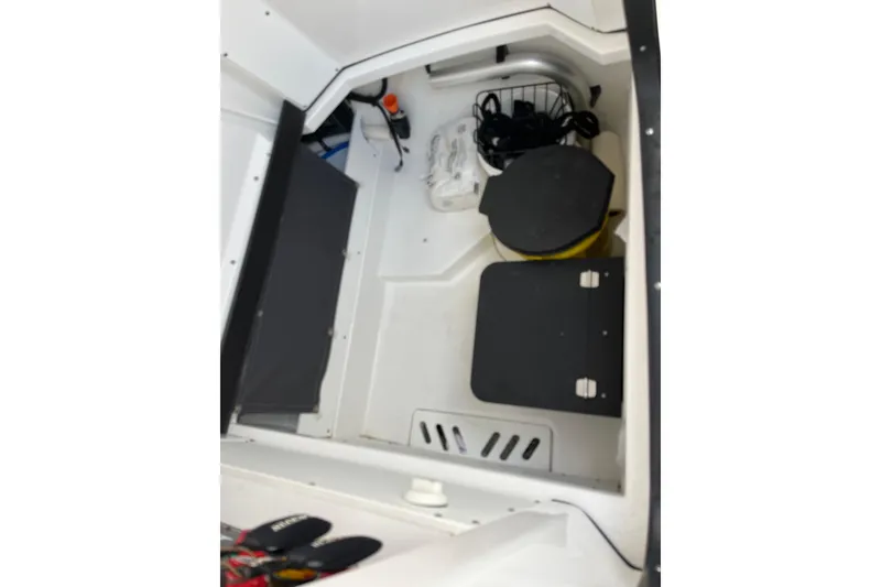 Slide: The Image of Interior storage compartment of 2019 Blackfin 272 CC boat with equipment and supplies. - 47