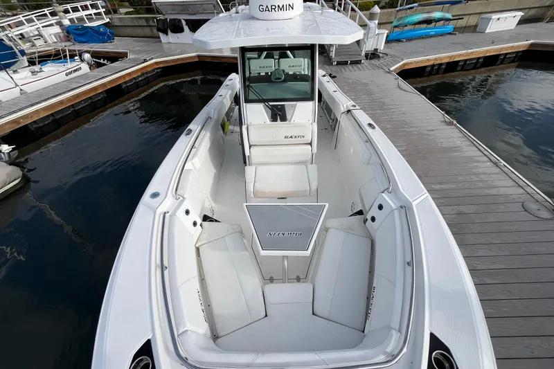 Slide: The Image of 2019 Blackfin 272 CC boat docked, featuring spacious seating and Garmin navigation. - 6