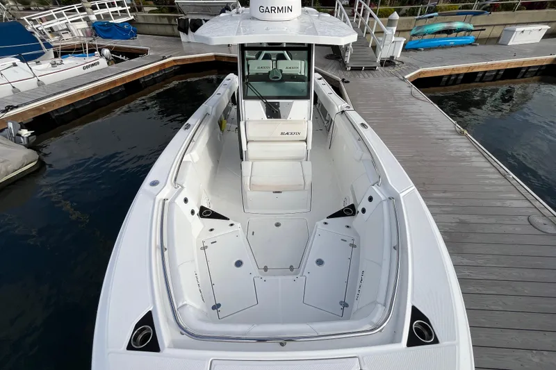 Slide: The Image of 2019 Blackfin 272 CC boat docked, featuring spacious deck and Garmin equipment. - 7