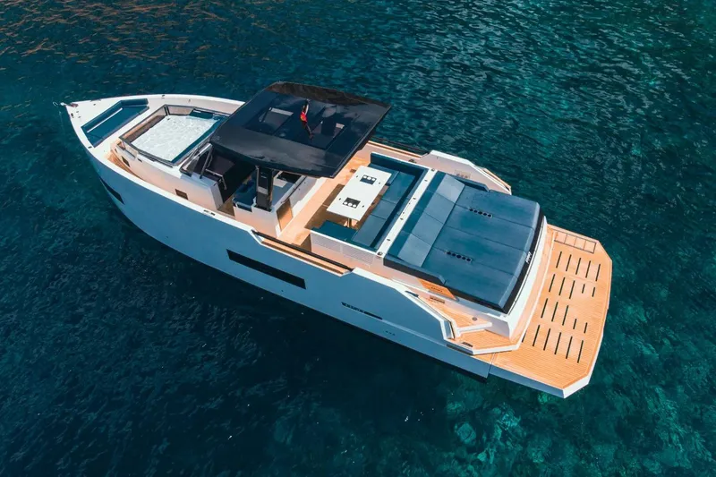 Slide: The Image of 2026 De Antonio Yachts 50 Open on clear blue water, aerial view. - 8