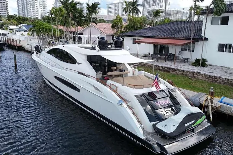 The Image of 2009 Lazzara LSX 75 yacht docked by waterfront homes, featuring sleek design and luxury amenities. - 0
