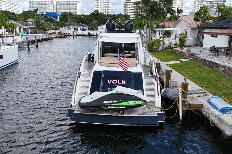 Slide: The Image of 2009 Lazzara LSX 75 yacht docked with Sea-Doo jet ski, American flag displayed. - 1