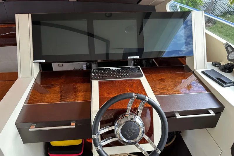 Slide: The Image of Helm station of 2009 Lazzara LSX 75 yacht with dual screens and steering wheel. - 24
