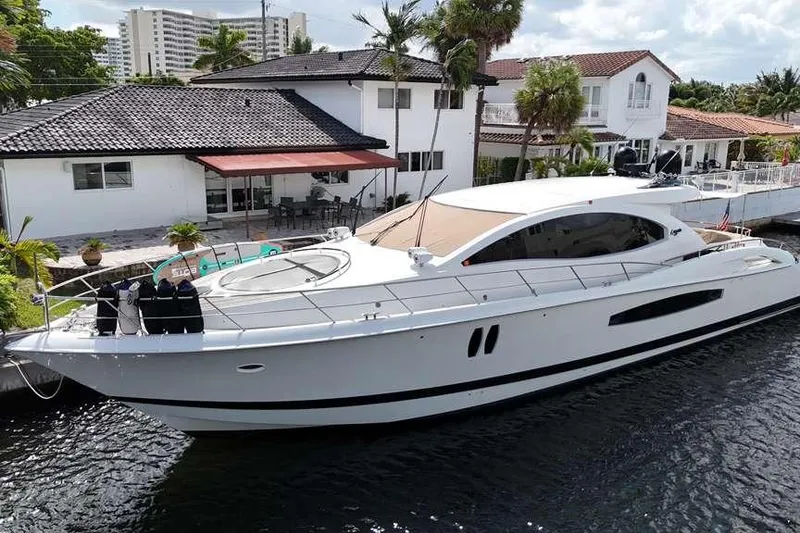 Slide: The Image of 2009 Lazzara LSX 75 yacht docked by waterfront homes. - 9