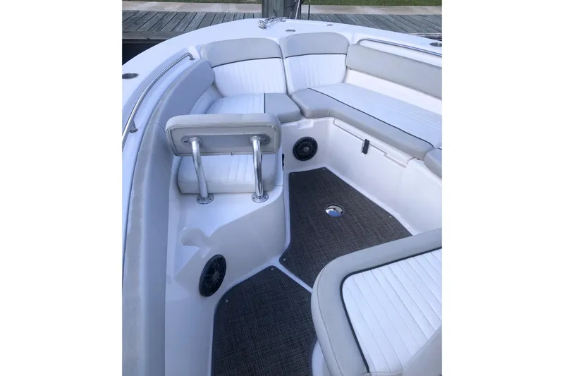 Slide: The Image of 2021 Sea Fox 249 Avenger boat interior with cushioned seating and carpeted flooring. - 11