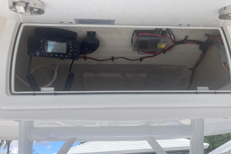 Slide: The Image of 2021 Sea Fox 249 Avenger electronics compartment with radio and wiring. - 16