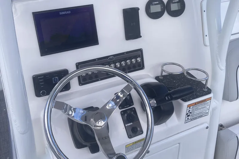 Slide: The Image of 2021 Sea Fox 249 Avenger boat dashboard with steering wheel and electronic controls. - 18