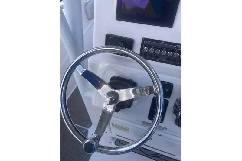 Slide: The Image of Steering wheel and controls of 2021 Sea Fox 249 Avenger boat cockpit. - 23