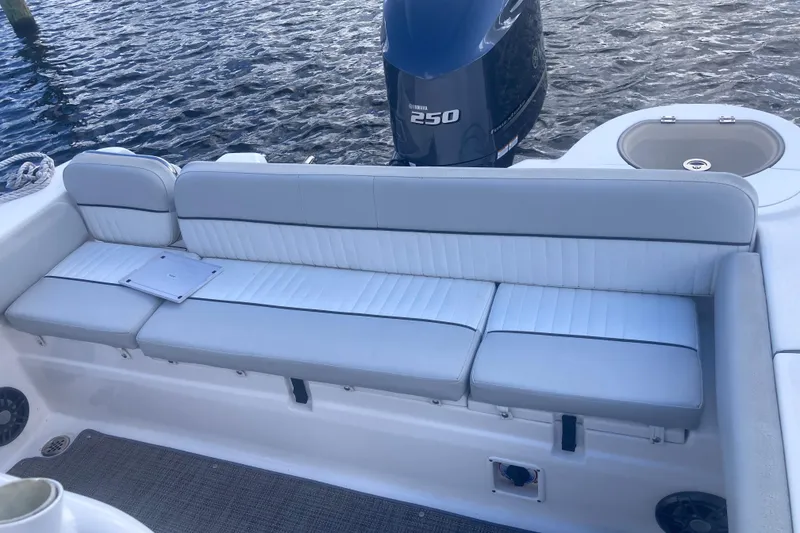 Slide: The Image of 2021 Sea Fox 249 Avenger boat interior with cushioned seating and Yamaha 250 engine. - 24