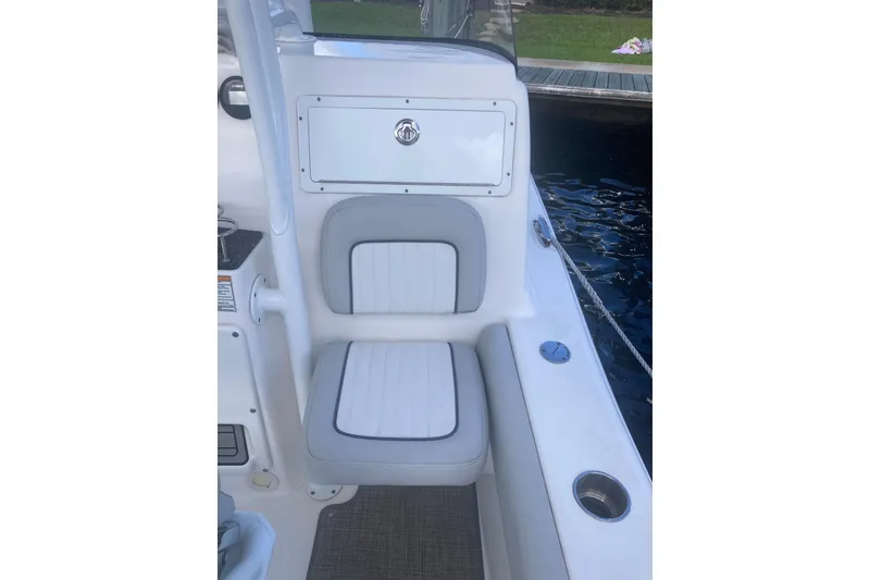 Slide: The Image of 2021 Sea Fox 249 Avenger boat seat with storage compartment, dockside view. - 29
