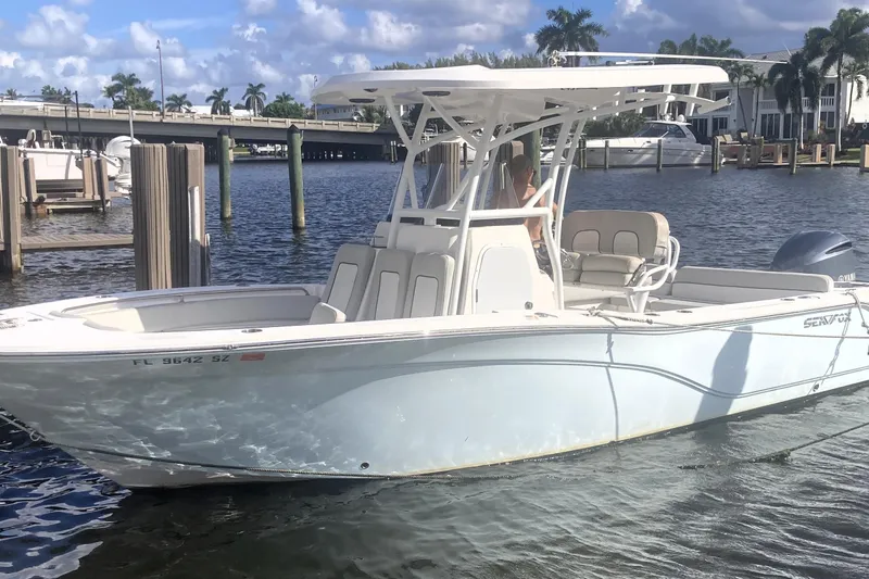 Slide: The Image of 2021 Sea Fox 249 Avenger boat docked in sunny marina setting. - 3