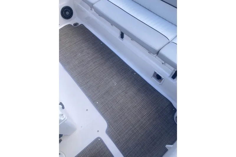 Slide: The Image of 2021 Sea Fox 249 Avenger boat interior with cushioned seating and textured flooring. - 31