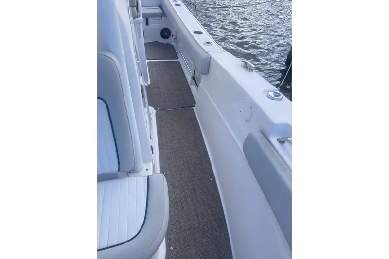 Slide: The Image of 2021 Sea Fox 249 Avenger boat interior with cushioned seating and water view. - 34