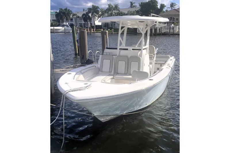 Slide: The Image of 2021 Sea Fox 249 Avenger boat docked in a marina, featuring sleek design and spacious seating. - 4