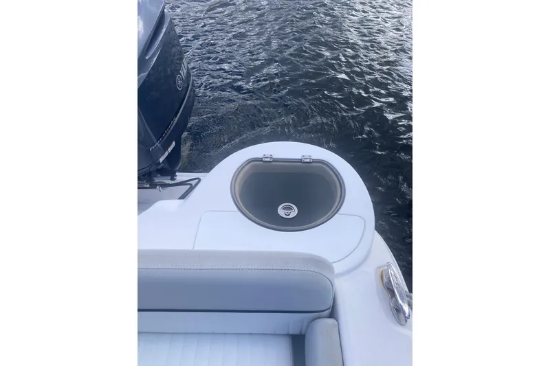 Slide: The Image of 2021 Sea Fox 249 Avenger boat with livewell and outboard motor on water. - 45