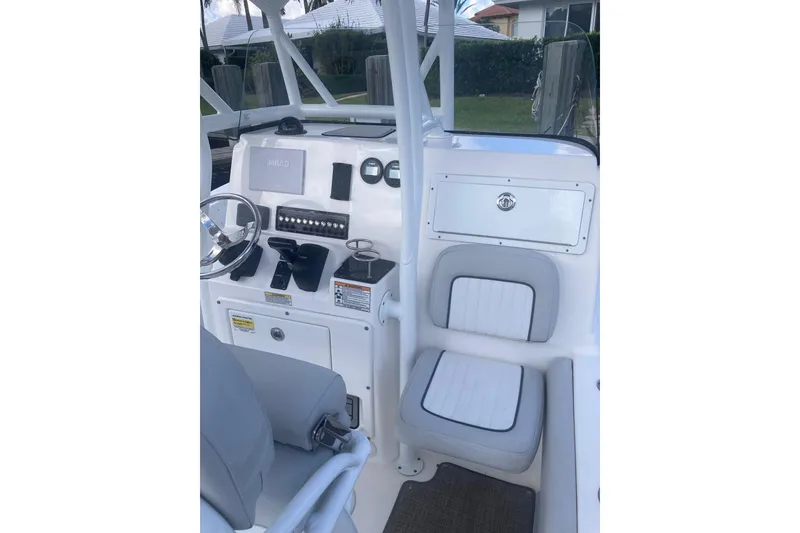 Slide: The Image of 2021 Sea Fox 249 Avenger boat console with steering wheel and seating. - 47