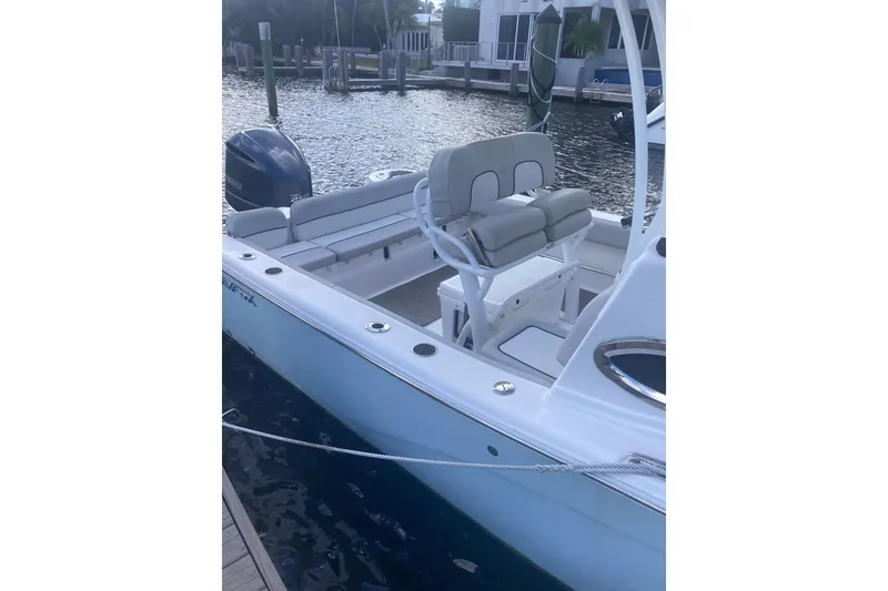 Slide: The Image of 2021 Sea Fox 249 Avenger boat docked, featuring seating and Yamaha outboard motor. - 48